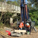 Two workmen undertaking a geotechnical investigation