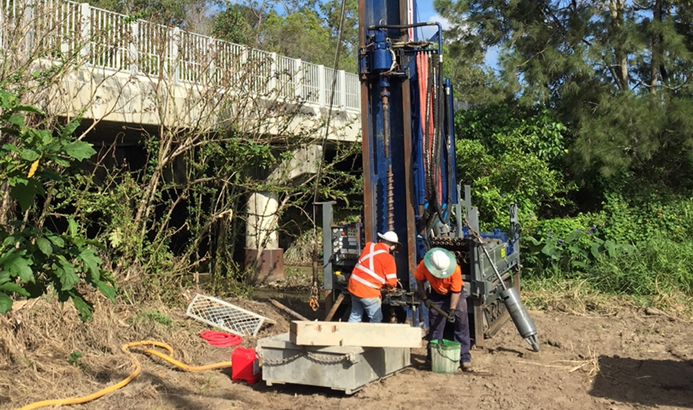 Two workmen undertaking a geotechnical investigation